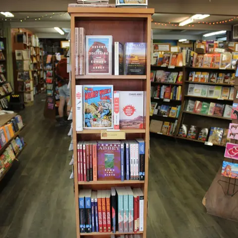 A bookcase displaying various books inside a bookstore.