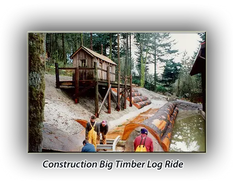Workers construct a log ride structure outdoors.