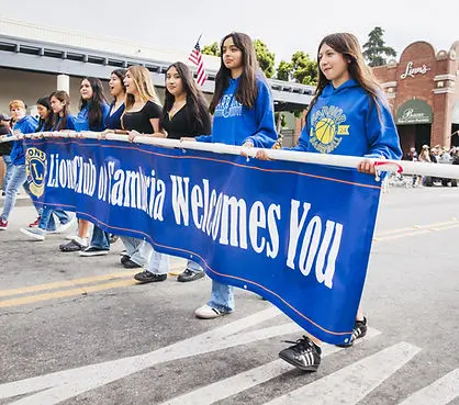 A group of young people carrying a banner in a parade.