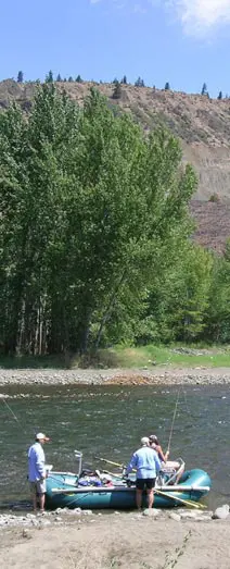 People fishing from a raft on a river.