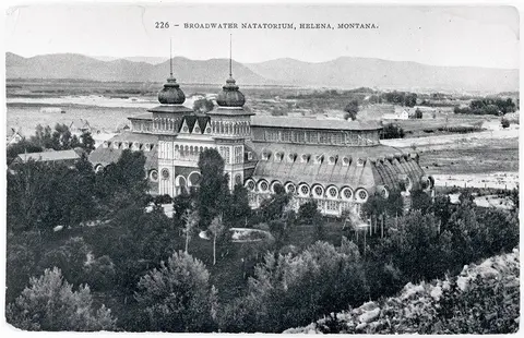 An old black and white photograph showing the exterior of a large ornate building with twin towers.