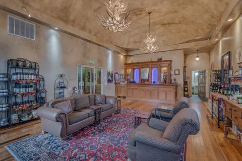 An interior shot of a rustic tasting room with a bar and seating area.