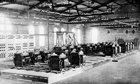A historic photograph showing the interior of an electrical equipment room filled with machinery.