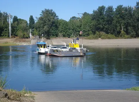 A car ferry crossing a river.
