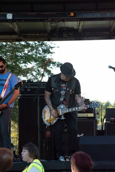 A band playing music on an outdoor stage.