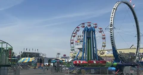An outdoor view of carnival rides at a fair.