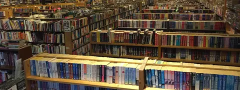 An interior view of a bookstore with rows of bookshelves filled with books.