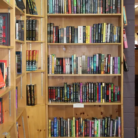Wooden bookshelves filled with many rows of books.