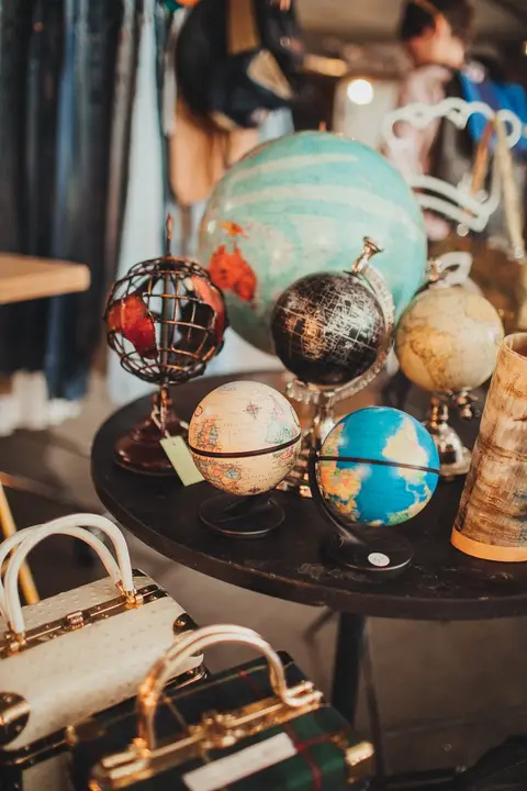 A collection of small globes and purses on a table indoors.