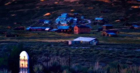 An elevated view of historic buildings in a valley at dusk.