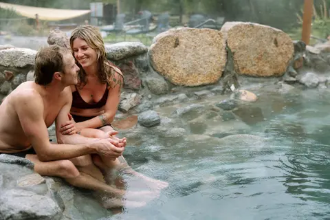 A couple relaxing in a hot spring pool.