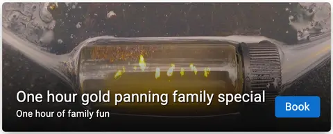 A small glass vial filled with liquid and gold flakes.