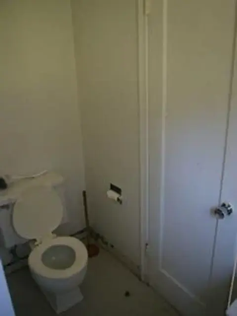 A photo of a toilet inside a bathroom.