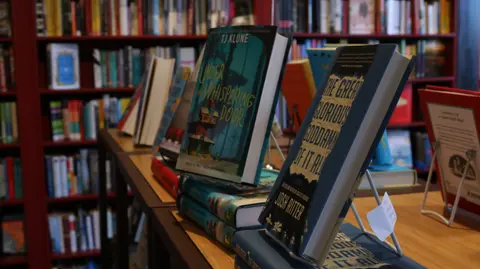 A display of books on a table inside a bookstore.