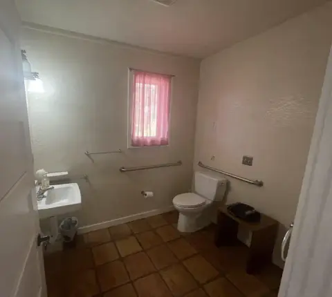 An interior view of a restroom with a sink and toilet.