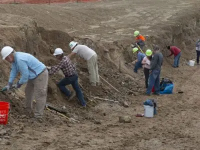 People working at an archaeological dig site.