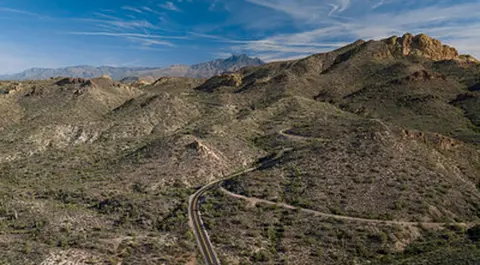 A winding road through a mountainous desert landscape.