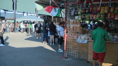 A busy outdoor market or festival with vendors and crowds.