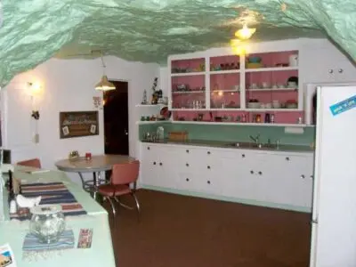 An interior view of a kitchen with a cave-like ceiling.