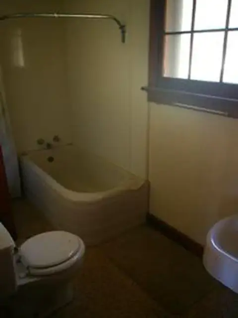 A small bathroom with a bathtub and toilet.