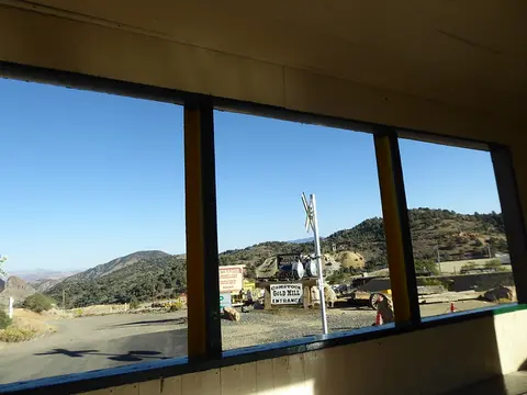 A view of a mountain landscape through large windows from inside a building.