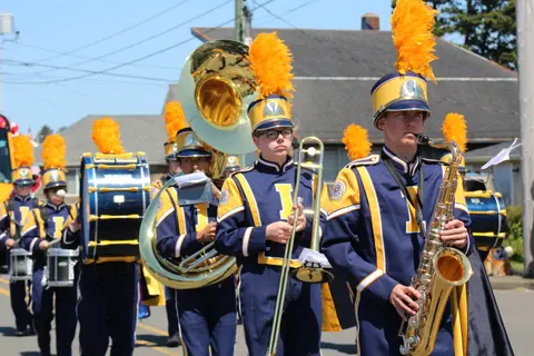 A marching band performs in a street.