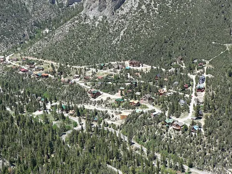 An aerial view of a mountain community nestled among trees.