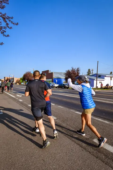 People running together down a street in a race.