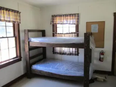 Interior view of a room featuring a wooden bunk bed.