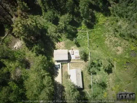An aerial view of a building in a wooded area.