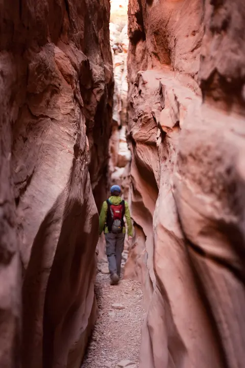 Hiker in canyon, Little Wild Horse Trailhead.