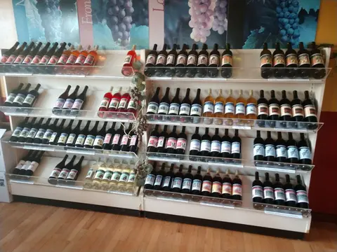 Shelves filled with various bottles of wine inside a store.