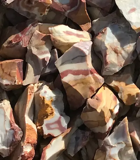 A collection of colorful banded jasper rocks.