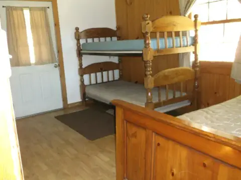 An interior shot of a room with wooden bunk beds.