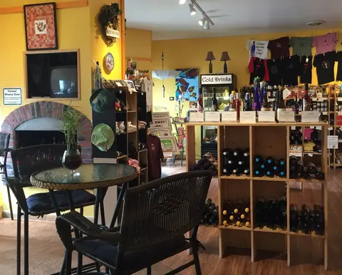 An interior view of a store displaying wine bottles and merchandise.