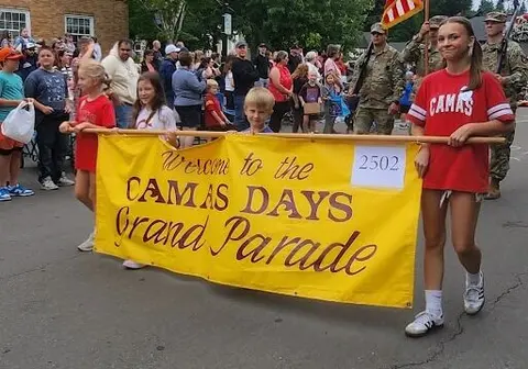 People carrying a parade banner in a parade.