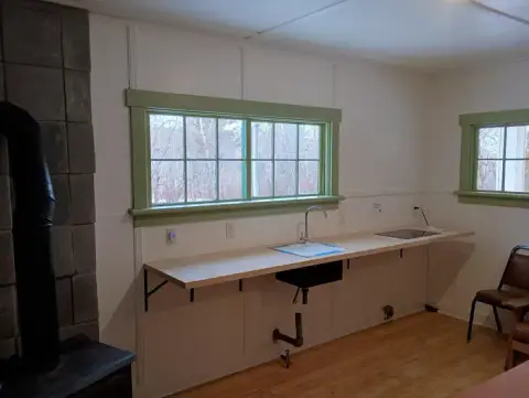 A photo showing the interior of a room with a counter and sink.