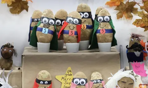 A collection of decorated potato figures displayed as superheroes and characters.