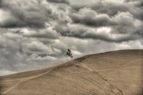 Dirt bike on sand dunes, Christmas Valley Byway.