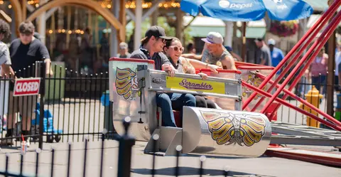 People riding an amusement park ride.