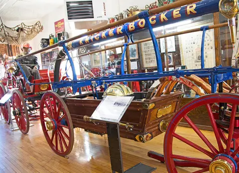 A vintage Knickerbocker fire engine on display inside a museum.