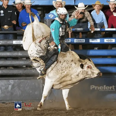 A bull rider during a rodeo event.