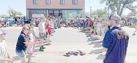 People participating in an outdoor community event in front of a building.