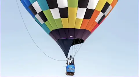 A colorful hot air balloon in flight.