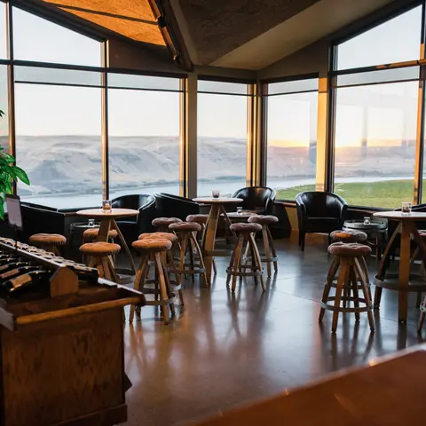 An interior space with large windows overlooking a scenic landscape.
