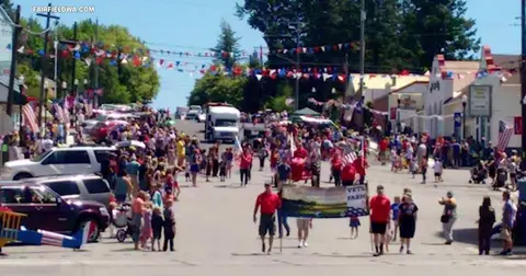 A crowd of people participating in a street parade.
