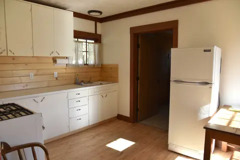 A photograph shows the interior of a rustic kitchen.