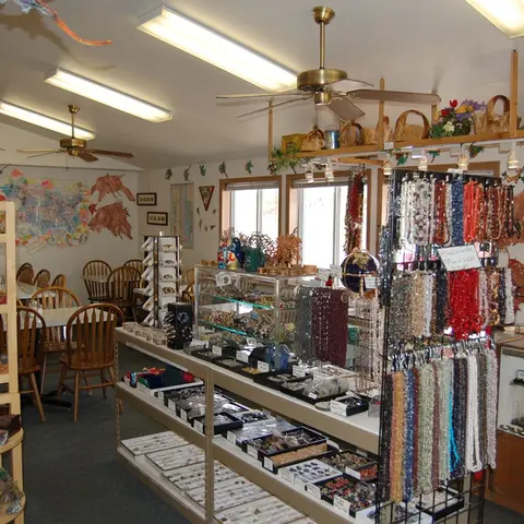 An interior view of a gift shop filled with jewelry, displays, and tables.