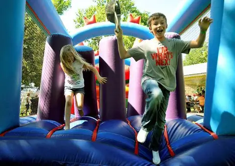 Children jumping inside an inflatable bounce house.