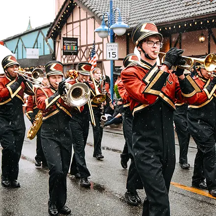 A marching band performs in a street parade.